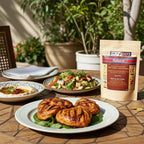 Baharat spice blend pouch on an outdoor table with grilled patties, salad, and a plate of dip.