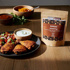 Spice n Easy Berbere spice blend pouch beside a plated spiced meat dish with vegetables