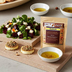 Dukkah pouch on a stone board with beet salad, olive oil bowls, and rounds topped with dukkah.